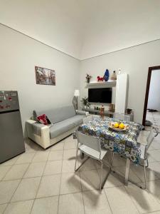 a living room with a couch and a table at La Casetta di Romeo in Trapani