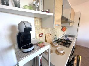a kitchen with a coffee maker on a counter at Casa I Corbezzoli - Paduledda - Isola Rossa in Cascabraga