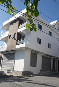 a large white building with doors and windows at ALTOS DE VIRGINIA 57 in Sánchez