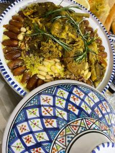 two plates of food sitting on a table at 1001-Nights Palace in Nebeur
