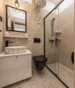 a bathroom with a shower with a toilet and a mirror at Apartment Zastupac 8761c in Hvar