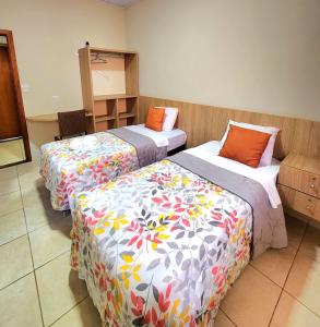2 Betten in einem Hotelzimmer mit in der Unterkunft Malta Hotel in Ilha Solteira