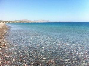 a large body of water with rocks in it at Corafili Holiday Suites in Kiotari