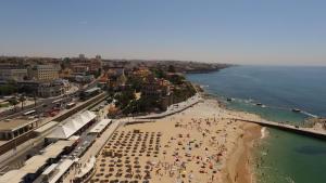 an aerial view of a beach with people on it at Vila Galé Estoril in Estoril