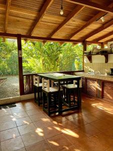 a kitchen with a table and chairs on a patio at Hotel Exotic Lodge in Puerto Viejo