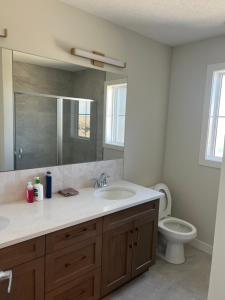 a bathroom with a sink and a toilet at Lovely 4 bedroom House in Calgary