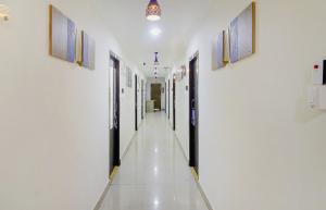 an empty corridor in a hospital with paintings on the walls at Super OYO Flagship Relax Grand Near Snow World in Hyderabad