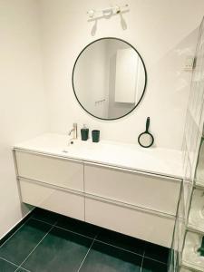 a bathroom with a white sink and a mirror at 3 BR home for 6 guests, Hoyvík, Tórshavn in Hvítanes +30 photos