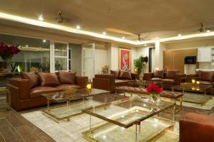 a large living room with couches and tables at The Loft Grande in Lahore