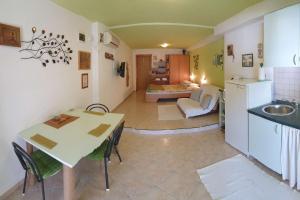 a kitchen and living room with a table and a sink at Apartments by the sea Murter - 22397 in Murter
