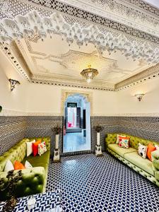 a living room with couches and a coffered ceiling at Riad Dilar Fes & Spa in Fès