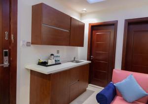 a small kitchen with a sink and a counter at Wow Hotel Jeddah in Jeddah