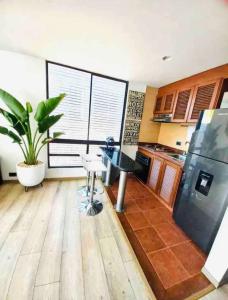 a kitchen with a desk and a large window at Ultimate Whole Floor Apartment in Bogotá +26 photos