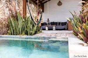 a swimming pool in front of a house with a couch at Lodge Kara in Grand-Bourg +32 photos