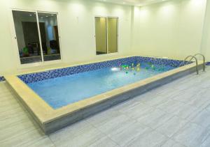 a large swimming pool in a room with at Wow Hotel Jeddah in Jeddah
