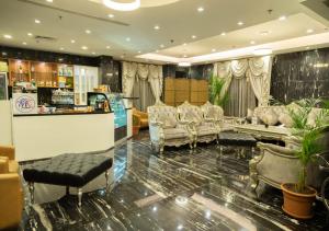 a waiting room with chairs and a bar at Wow Hotel Jeddah in Jeddah