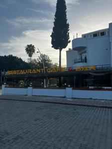 a building with a sign that reads permanent car dealership at Kemer Manastır Hotel in Kemer