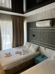 a hotel room with a bed with towels on it at Kemer Manastır Hotel in Kemer