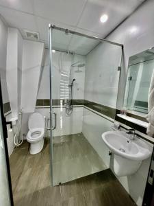 a bathroom with a shower and a toilet and a sink at HPT Apartment chuỗi căn hộ Hoàng Huy Riverside HP in Abbeyfeale