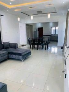 a living room with a couch and a table at 2nd street home in Lusaka