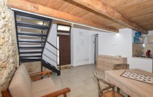 a kitchen and a dining room with a spiral staircase at Nice Apartment In Noto With Wifi in Noto