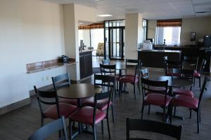 a restaurant with tables and chairs and a kitchen at Red Roof Inn Staunton in Staunton