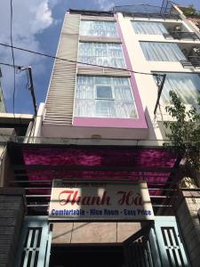 a pink building with a sign in front of it at Thanhha Guesthouse in Ho Chi Minh City