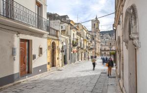 a group of people walking down a street at Gorgeous Apartment In Chiaramonte Gulfi With Kitchen in Chiaramonte Gulfi