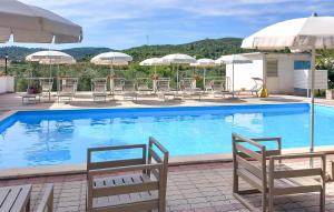 a large swimming pool with chairs and umbrellas at Nice Apartment In Vieste With Wifi in Vieste +22 photos