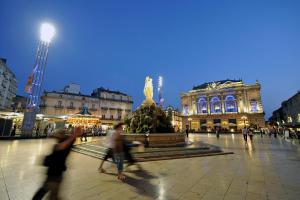 a group of people walking around a plaza with a statue at Villa Bellagio Euromedecine by Popinns in Montpellier