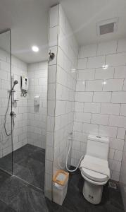 a bathroom with a toilet and a shower at AreNice Boutique Hotel in Suratthani
