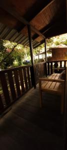 a wooden porch with a bench on a deck at Bosque Secreto - Private Cabin and Camping in Quito