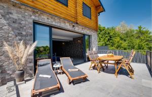 a patio with a wooden table and chairs at Pet Friendly Home In Petrinja With Wi-fi in Petrinja