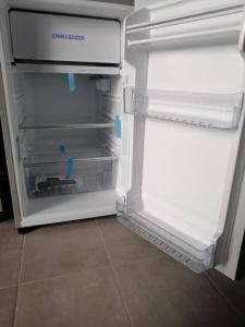 an empty refrigerator with its door open in a kitchen at Apartamento en La Candelaria, centro histórico Bogotá in Bogotá