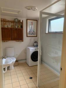a bathroom with a washing machine and a sink at Apartment minutes to Lake in Jindabyne