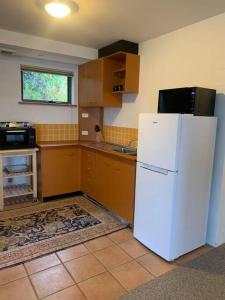 a kitchen with a white refrigerator and a sink at Apartment minutes to Lake in Jindabyne