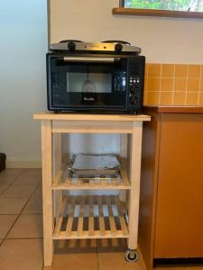 a microwave on a table in a kitchen at Apartment minutes to Lake in Jindabyne