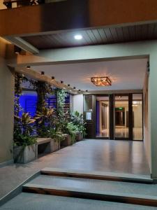 a hallway of a building with potted plants at Apart dos ambientes - Macrocentro Salta in Salta