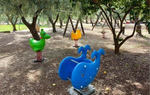 a playground with three play equipment in a park at Lovely Apartment In Vieste With Wifi in Vieste