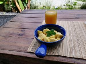 a bowl of food and a glass of orange juice at Glamping Orosierra in Chinchiná