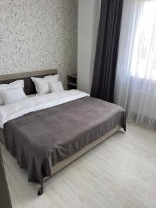 a bedroom with a large bed with white pillows at Apart Elite in Bălţi
