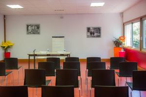 an empty room with chairs and a table in it at Résidence ATC ROUTES DU MONDE in La Grande Motte