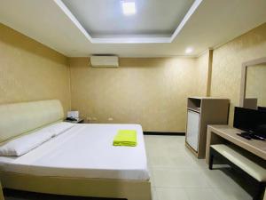 a bedroom with a bed and a desk and a television at PJ INN HOTEL in Angeles