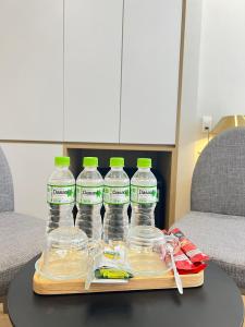 a tray with four bottles of water on a table at Phương Mai Hotel Đà Lạt in Da Lat