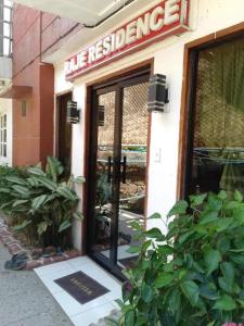 an entrance to a restaurant with a sign on the door at Raje Residence in El Nido