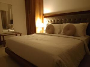 a bedroom with a large white bed with pillows at Entire 3 bhk by The Good Traveller in Mumbai