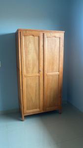 a wooden cabinet in a corner of a room at MEDPY HOSTEL in Pedro Juan Caballero