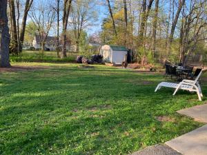 a park with a bench and a picnic table in the grass at Cozy First Floor Apartment in Chicopee