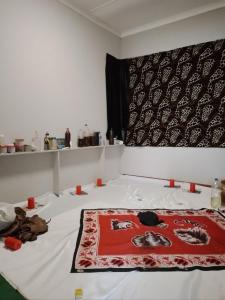 a room with a bed with a red blanket on it at The Best African Traditional Healer and Love Spell sangoma in Polokwane in Polokwane