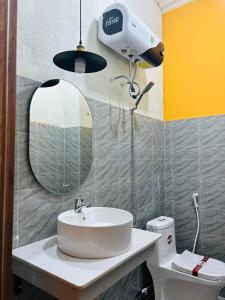 a bathroom with a sink and a mirror at Chino Homestay Măng Đen in Kon Tum